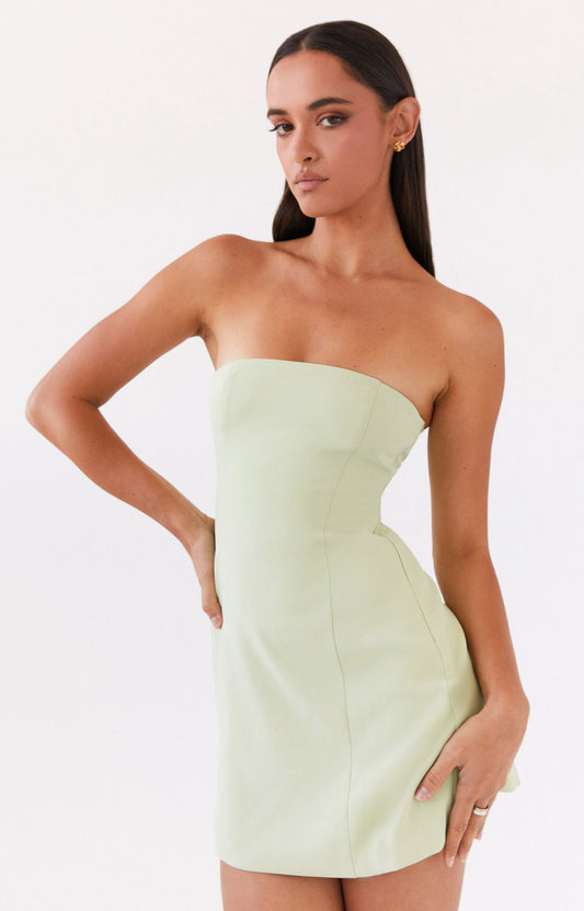 A woman wearing light green dress from Peppermayo US New Arrivals collection